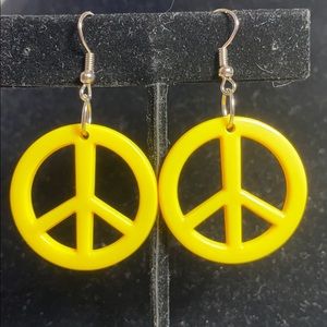 Small yellow peace sign earrings.